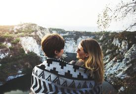 happy couple in winter mountains