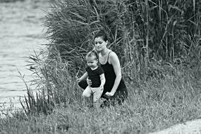 mom with baby on the river bank in black and white background