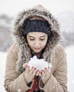 photo of a girl with a snow in her arms