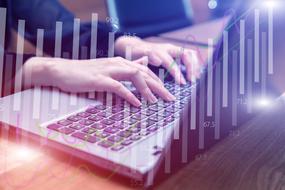 photo of female hands on laptop keyboard