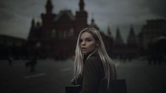 young blonde Girl on Red Square at dusk