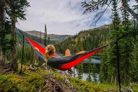 girl in a hammock by the lake