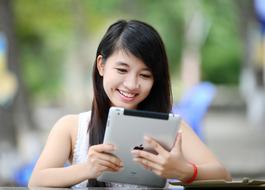 Asian girl looks in the iPad