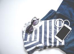 womens jeans, t-shirt, sunglasses and smartphone