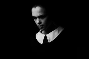 dark photo of angry girl in black and white dress