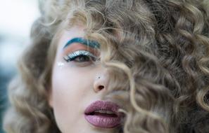 Portrait of sexy girl with bright makeup and curly Hair
