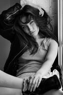 fashionable girl on the windowsill in black and white background