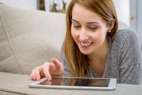 Relaxed young Woman with Tablet indoor