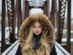 blonde in winter on the bridge