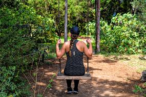 girl riding a swing