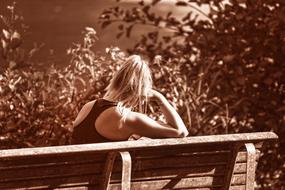 black and white photo of a lonely blonde on a bench