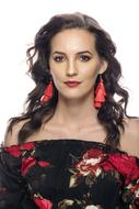 photo of a brunette with red earrings and a floral blouse