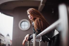 photo of a girl with makeup on the balcony