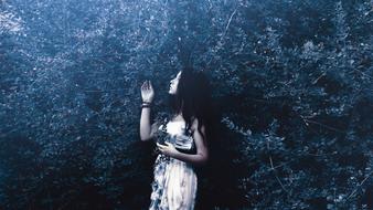 girl in a white dress in a mystical forest