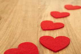 Beautiful, red heart figures, on the wooden table