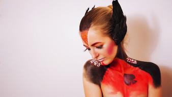 girl with body art in the form of a black swan