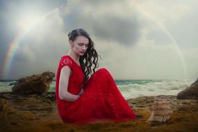 romantic woman in red dress on the beach