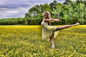 young girl standing on one leg in rape Field