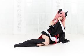 Beautiful girl with pink hair, posing in colorful anime clothing