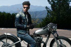 a man in a denim suit on a motorcycle