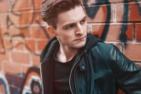male Fashion Model at grunge brick wall