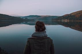 Woman on the beautiful landscape with the lake