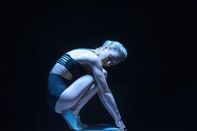 Athlete woman on the dark background