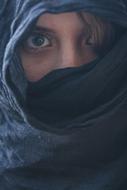 face of young Woman Covered with black scarf