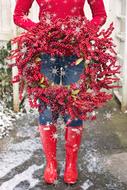 girl in red boots with a red wreath