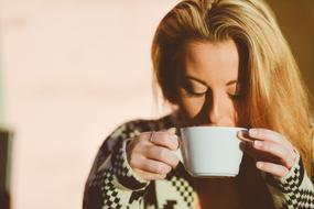 adult blonde Woman Drinking Coffee