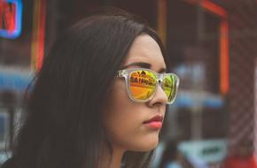 Portrait of the girl with sunglasses with colorful lenses