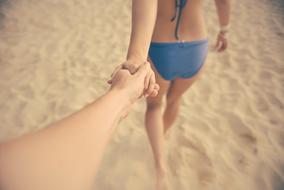 couple in love walking on the beach holding hands