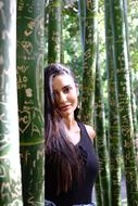 girl with long hair posing near a tree