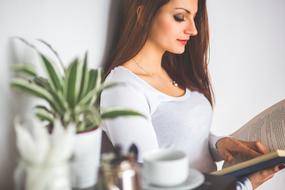 woman reading a book in the morning