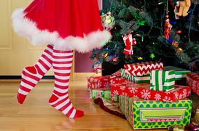 child girl in red and white clothe Decorating Christmas Tree