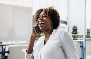 happy adult african american woman with phone