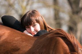 beautiful girl with a horse on a blurred background