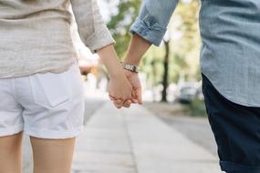 couple in love holding hands on blurred background