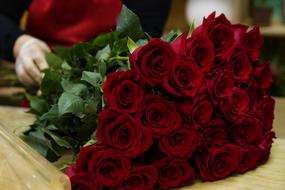 bouquet of red roses on a wooden table