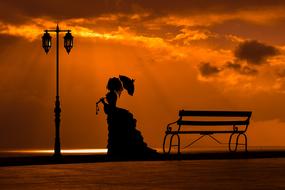 silhouette of a retro woman at sunset