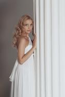 beautiful blonde posing in white dress
