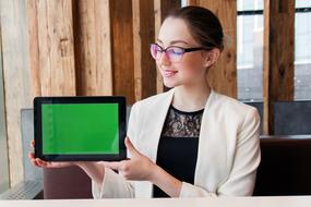 photo of a girl with a tablet with a green screen