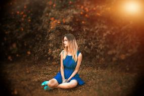 girl in a blue dress posing in nature