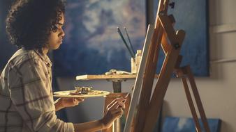 girl near the easel in the workshop