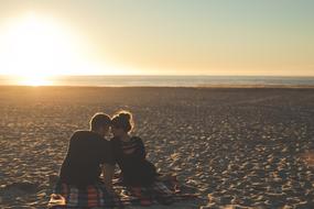 couple in love is resting on the evening beach