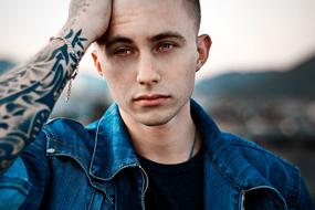 Portrait of young Man with tattoo on hand