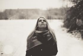 young girl in Winter clothing looking at sky