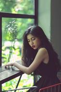 lonely sad asian model by the window