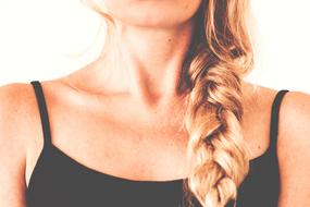 Woman in black clothing, with the blonde braid, in light