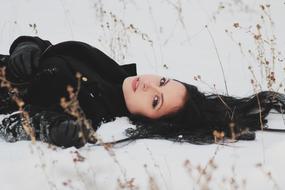 woman lying on snow